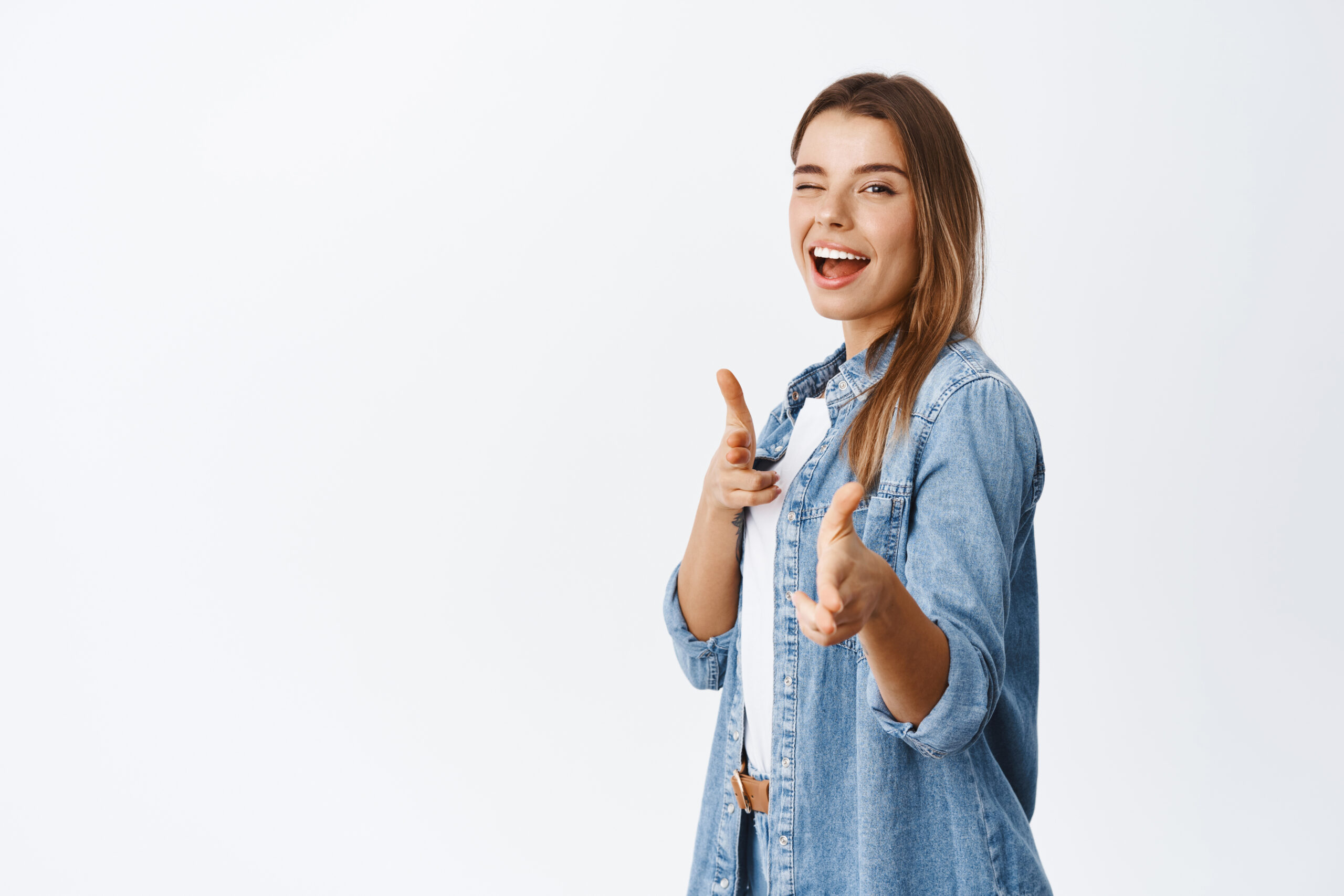 Pretty girl praising good job, standing half-turned and pointing